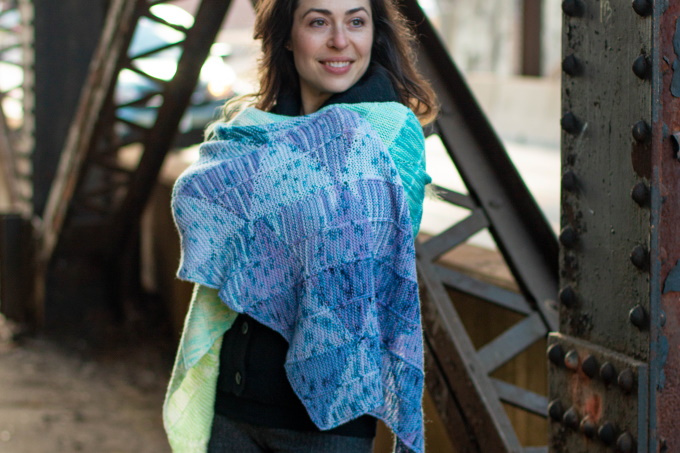 The Striad Wrap by Stephanie Alford, constructed in a series of short row triangles, knit individually in strips and joined together without any seaming up.