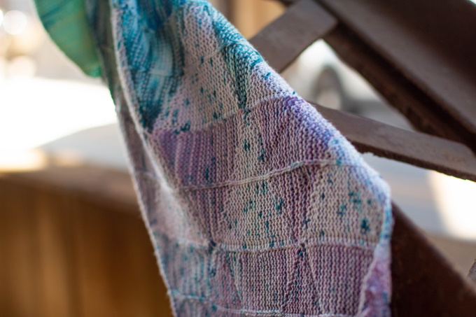 The Striad Wrap by Stephanie Alford, constructed in a series of short row triangles, knit individually in strips and joined together without any seaming up.